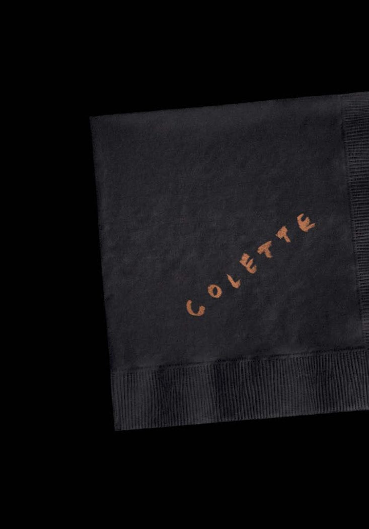 Black cocktail napkin with the Colette logo