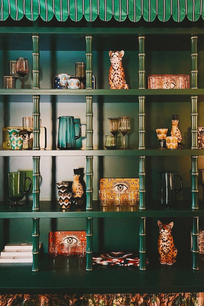 Green shelves with leopard ceramics