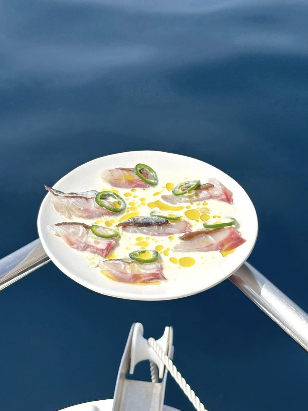 Raw fish with green chili served at sea
